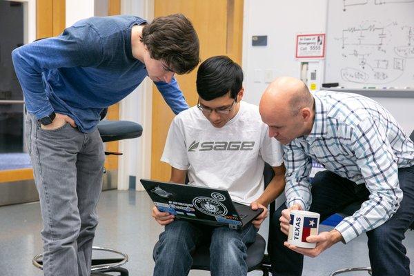 Brian Storey, Professor of Mechanical Engineering looks over students' work.