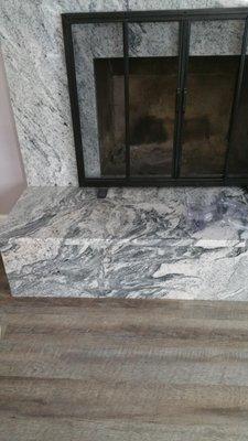 Matched up granite from a vertical to horizontal plane on a fireplace