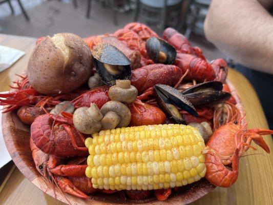 Huge bowl of Fresh Crawfish , corn , mushrooms and muscles w/ great seasoning.