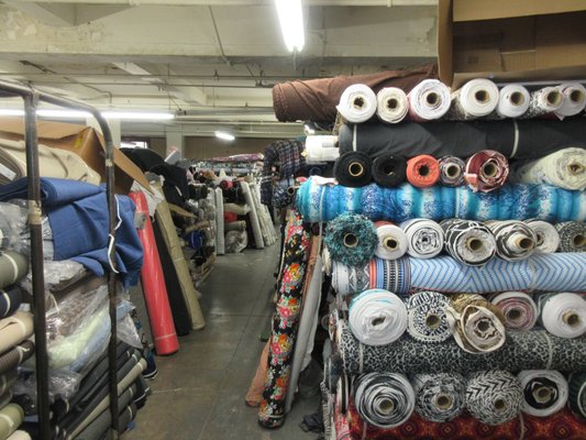 Full floor of apparel fabrics: linen, silk, cotton, wool, poly, etc.