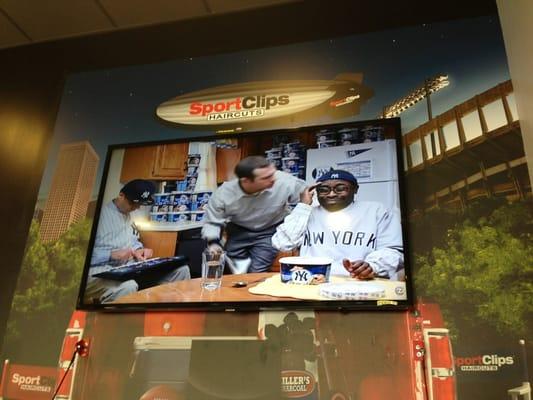 Huge screen television in waiting area.