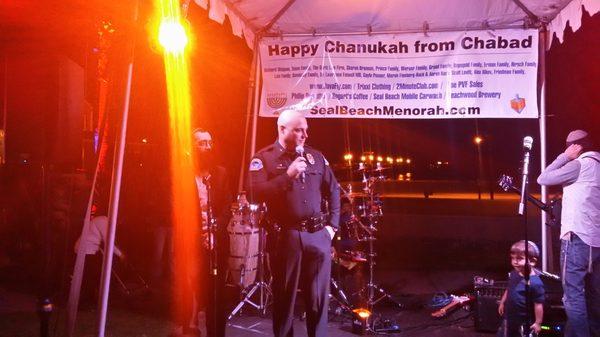 Seal Beach Police Officer addressing the crowd at the 8th Day Pier Chanukah Celebration, Sunday December 10, 2017