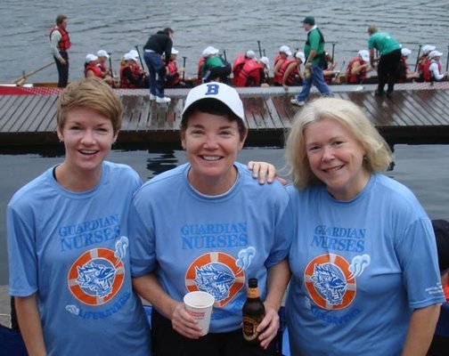 Georgette (left) and Kim (right) paddled for the Dragon Boat team organized by client Betty Long (center), president of Guard...