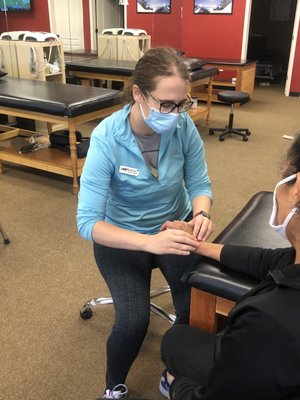 Hayley Poland PT, DPT works on her patients injured wrist.