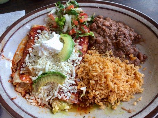 (White) cheese enchiladas with rice, refried beans, mini-salad, avocadio slices and a dollop of sour cream