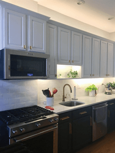 Painted Cabinetry with new lighting and backsplash