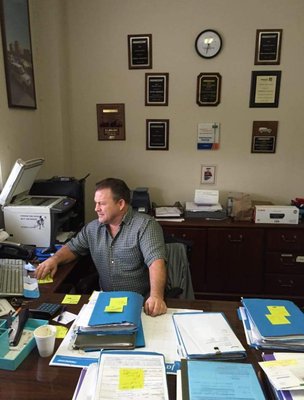 Pat hard at work with his wall of accolades behind him!