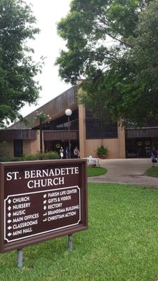 Front of the church. It's covered in trees.