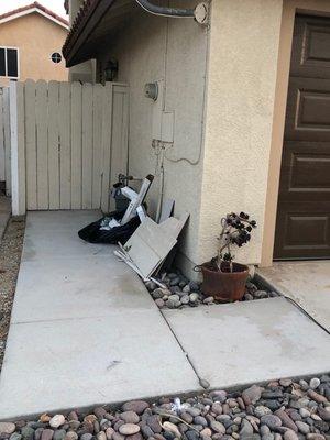 Trash on side of house which was noted by association.