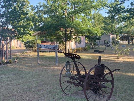 Cabins and 19th century settlers farm equipment