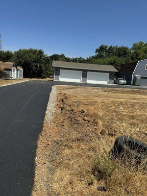 Asphalt driveway in u shape going to our beautiful new garage