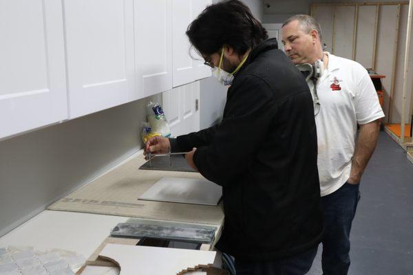 Tile, Grout & Thinsets Workshop:  Learning how to cut scribe tile for around a toilet flange.