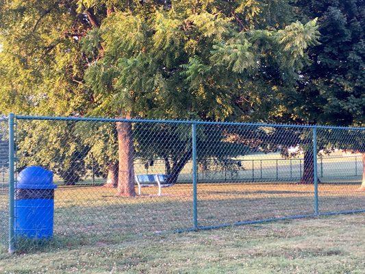 The fenced dog park includes benches for owners.