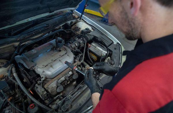 mechanic performing engine tune up