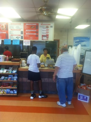 Right when you walk in the diner. The man in the yellow is half of the restaurant owner. His wife in the red is the other half.