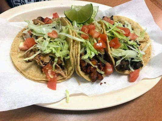 Chicken, Pastor, and Steak Tacos with Lettuce and Tomato.