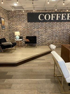 Coffee shop with exposed brick walls and comfy chairs.