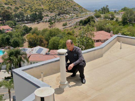 Roof and Exhaust Flue Inspection For Proper and Sealed Installation Assessment by lead home inspector Haitham.