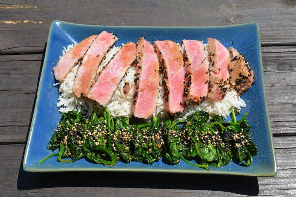 10 Oz Ahi tuna seared on olive oil, butter, soy sauce and lemon juice, served on a bed of basmati rice and steamed spinach with lime juice