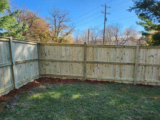 6ft tall fence with capped posts cemented in.