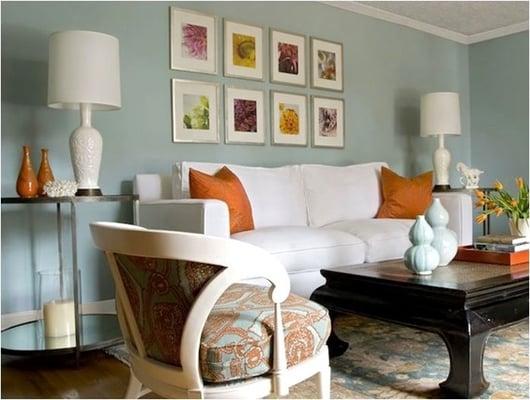 Blue, orange and white:  A neutral white sofa color allows the client to decorate with less permanent splashes of color.