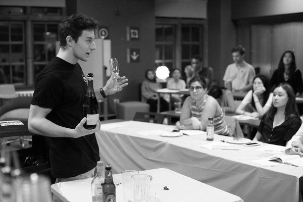 Patrick teaching the class how to properly pour sparkling wine