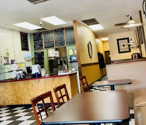 Counter, tables, and booths in the background.