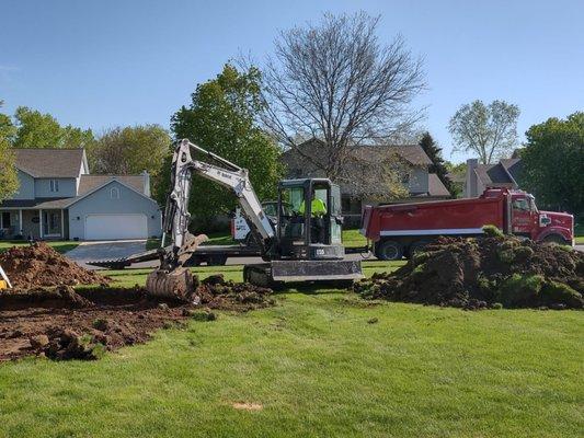 Excavating for adding on a new garage.