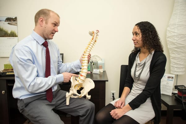 Dr. Patterson reviewing the causes of spinal pain with a patient.