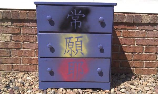 Trash As Art refurbished dresser painted with Kanji symbols.