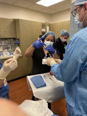 Nurse, doctor preparing for Thorentesis procedure.