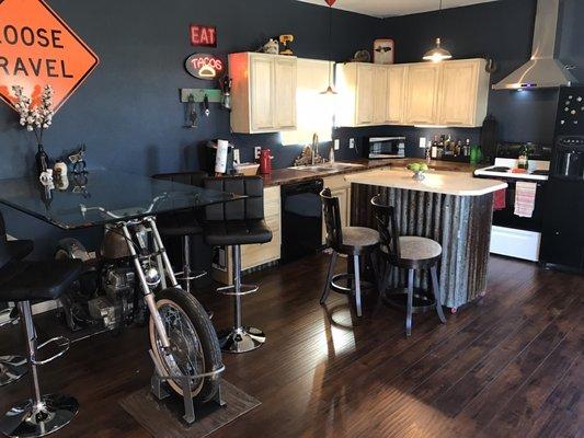 The dining room and kitchen, complete with a freaking motorcycle! So awesome!