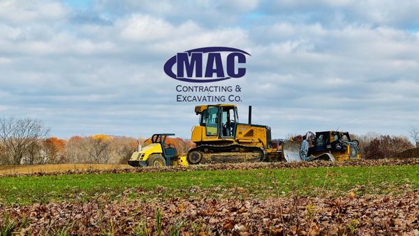 Dozer, Roller, & Skid Steer at building pad site .