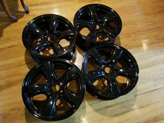 Gloss black powder coat. 18x8 wheels