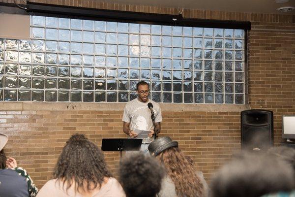 Guests listen to the words of a poet at one of the CRHC's monthly open microphone poetry events