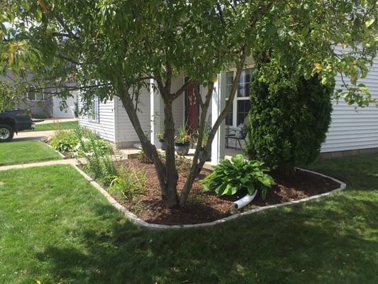 Brick borders make mowing easier and keeps mulch contained.