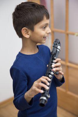 Young child taking a flute lesson