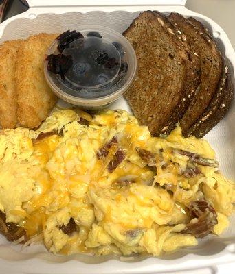 Scrambled breakfast with toast fresh fruit and hash browns. Delicious.