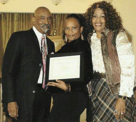 Dr James M Scoggins jr and 1st lady Warrenell Scoggins giving an award to Fancy Weatley