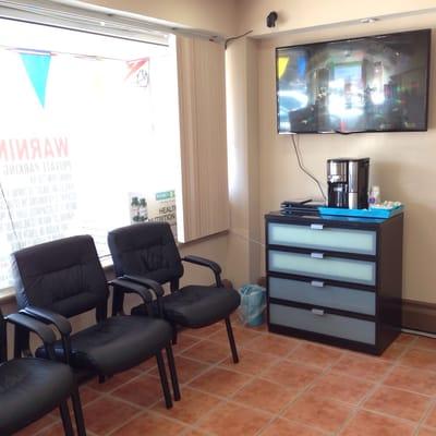 The seating area with a coffee machine and a tv.