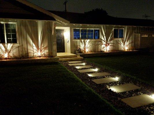 Lighting, sod, river rock, contempo paver stones, travertine entrance.