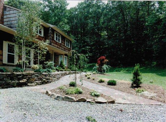 Project complete. Walkway added, retaining wall added, sod installed, shrubs and trees