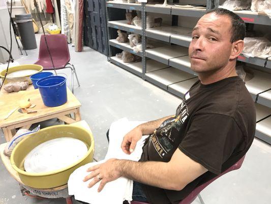 My husband getting ready to try out making pottery for the first time