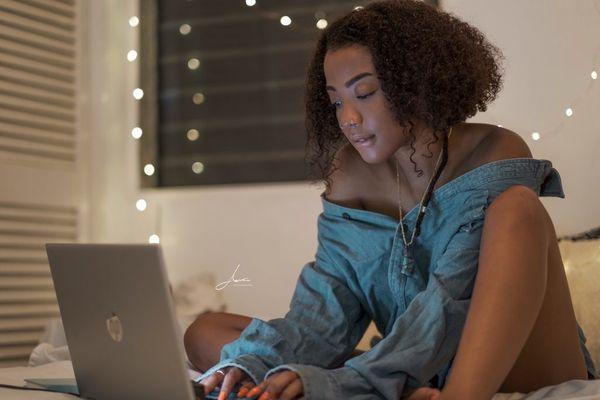 Young woman surfing the web in her private room