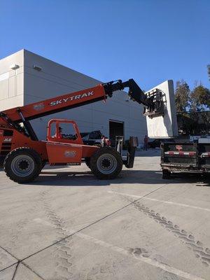 Boom lift to safely remove wall opening over window.