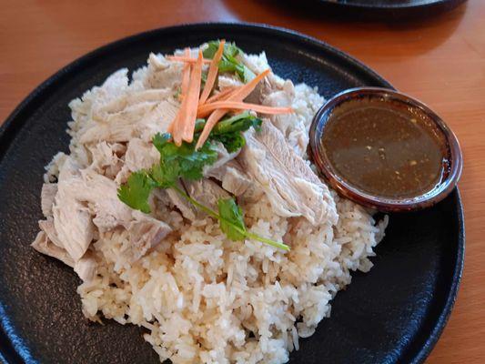 Boiled chicken, rice, and a spiced garlic sauce to pour over it.