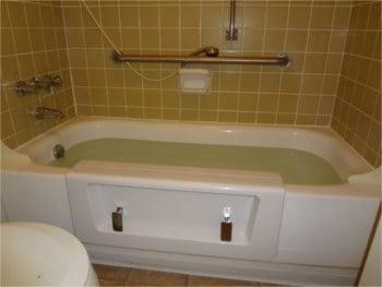 Accessible tub with door holding water.