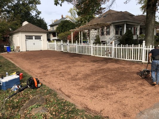 We removed a lot of weeds that were growing in the driveway. Then we spread new red 1/2 inch stone down.