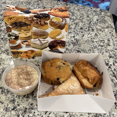 Rice pudding, blueberry muffin, strawberry turnover, and chocolate croissant