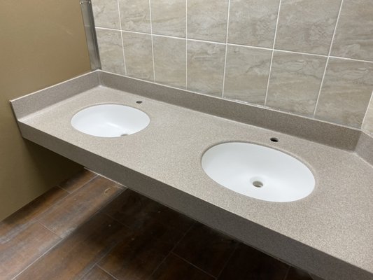 DuPont Corian Solid Surface Vanity top with integrated Corian sinks and integrated coved backsplash